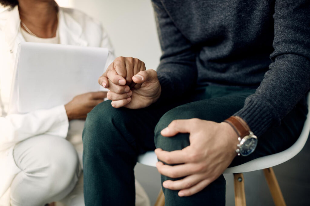 Doctor comforting a man during trauma-informed care in Mount Pleasant, WI.