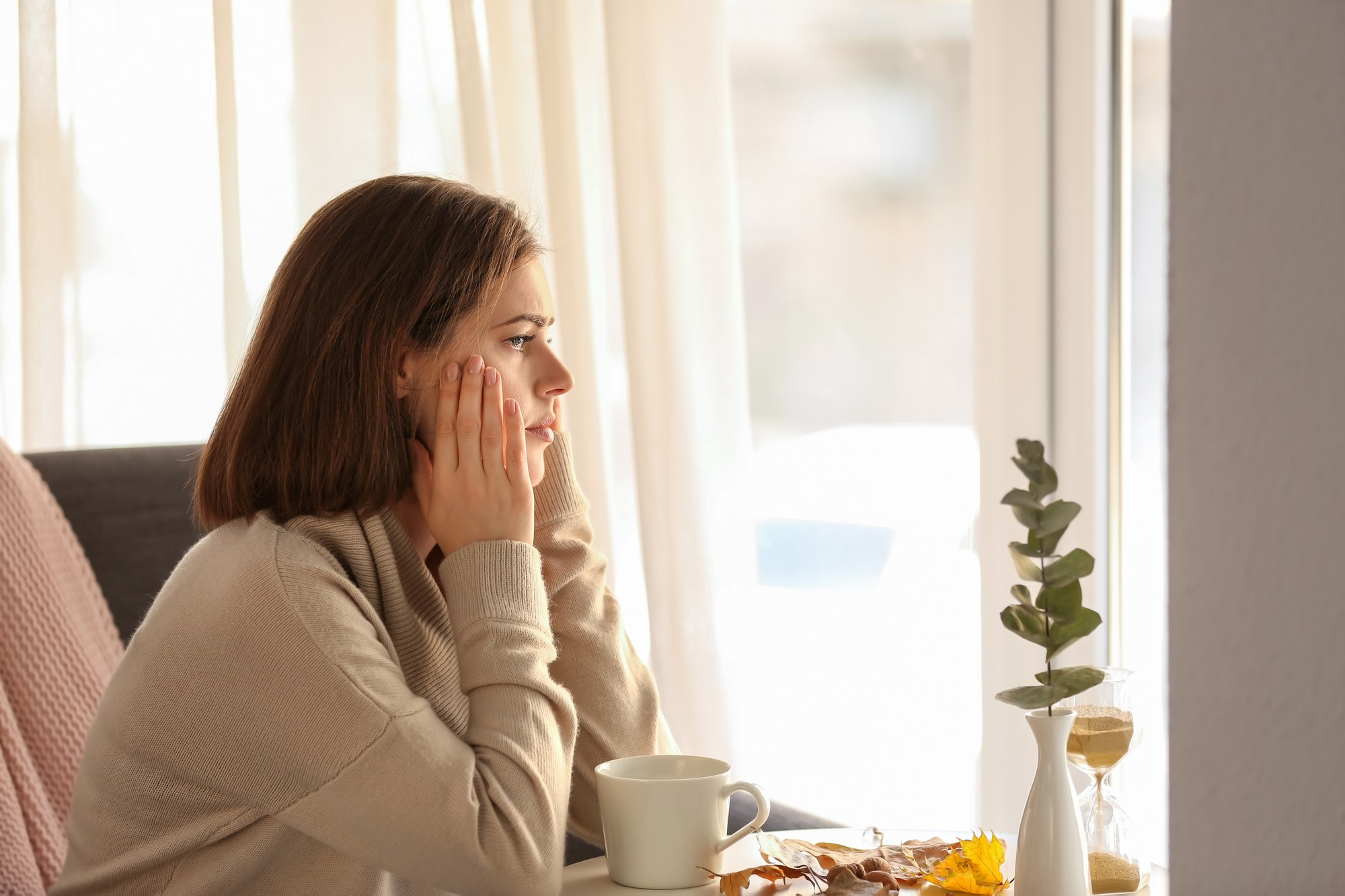 A woman considers virtual treatment through Axis Behavioral Health's anxiety treatment in Mt. Pleasant, WI.