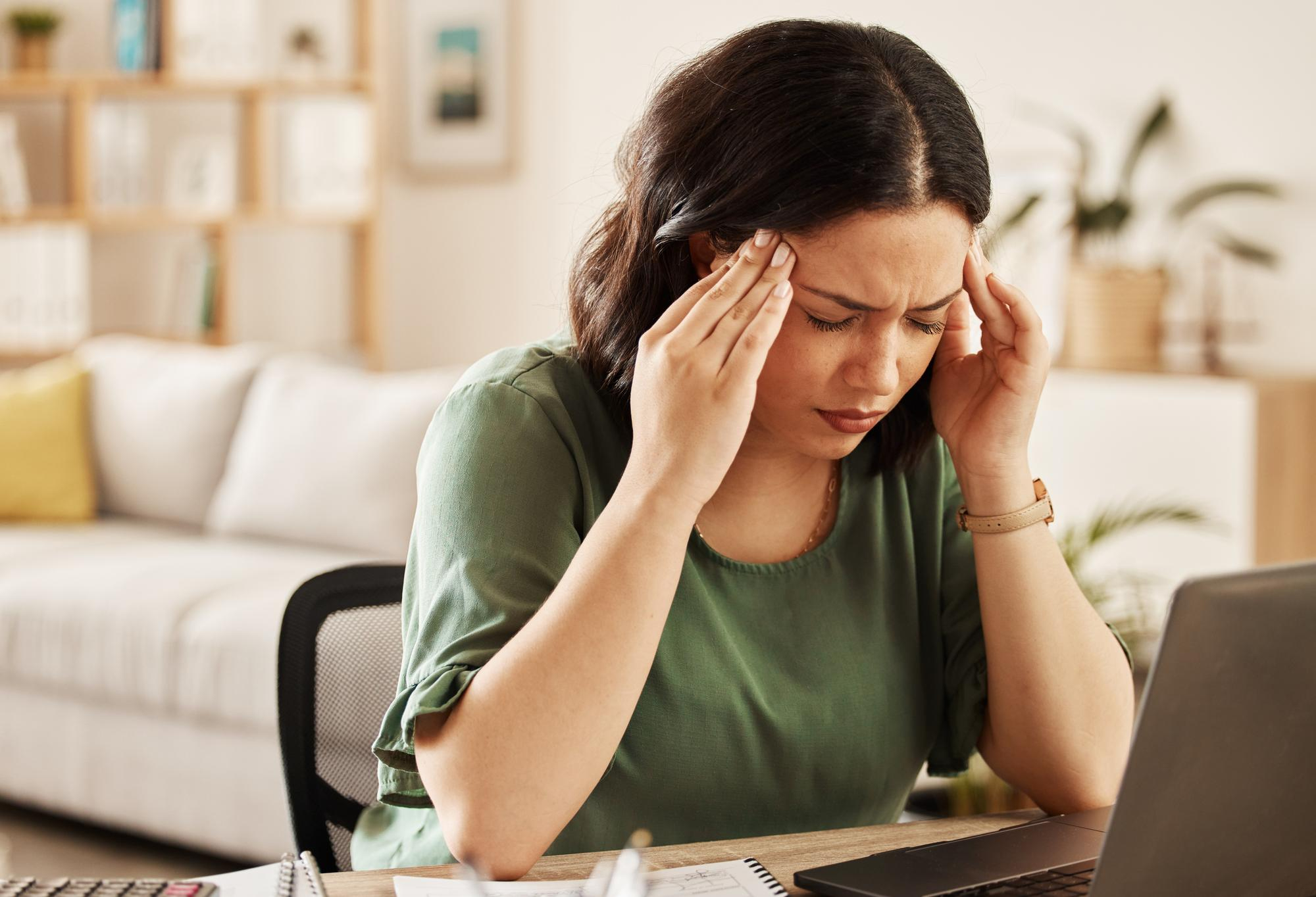 Woman sitting with her hands on her head during PTSD treatment in Mount Pleasant, WI.