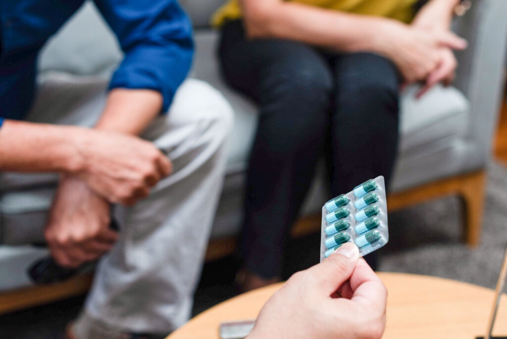 Doctor discussing medication options with a couple during medication-assisted treatment in Mount Pleasant, WI.