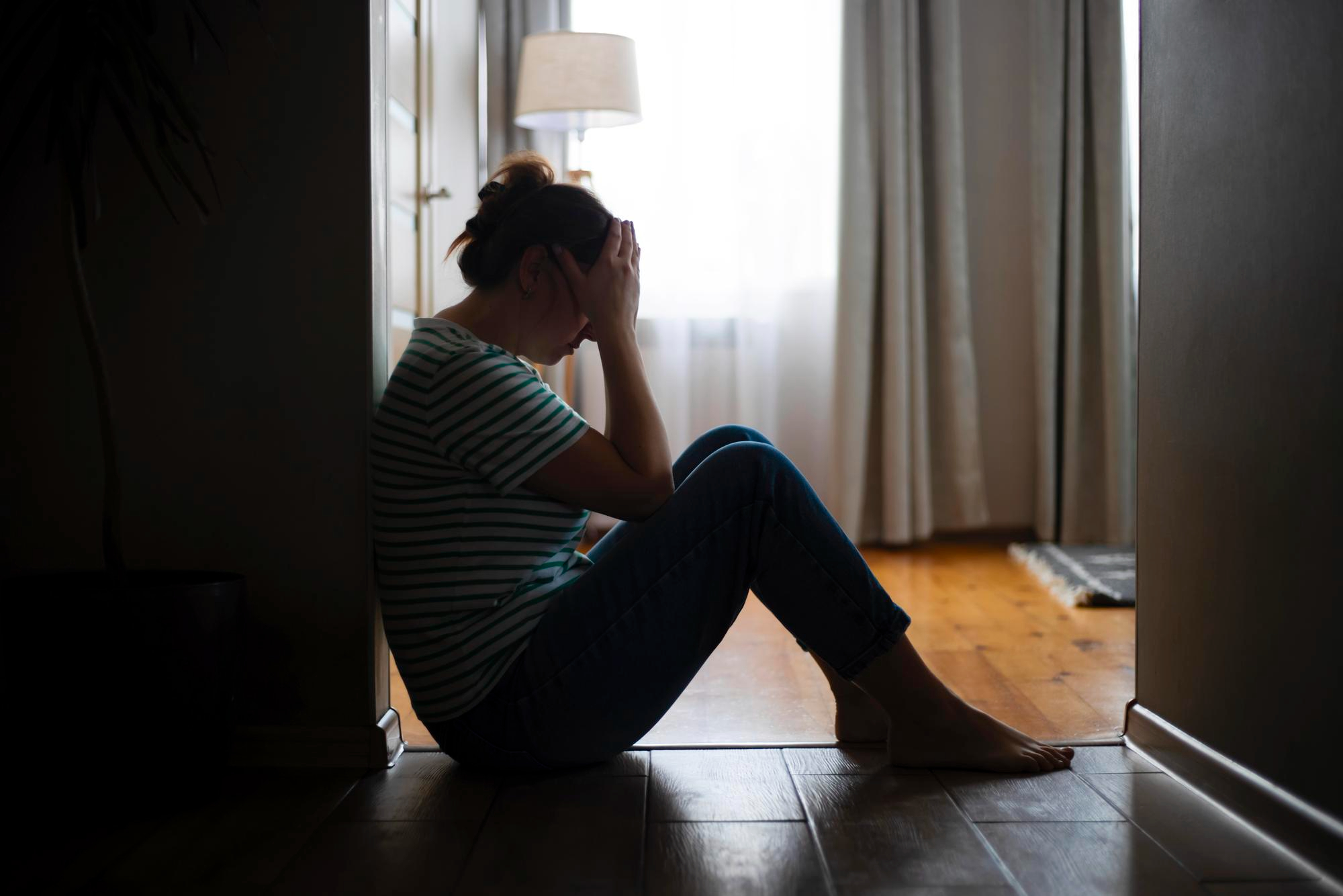 A woman considers reaching out to Axis Behavioral Health for depression treatment in Mt. Pleasant, WI.