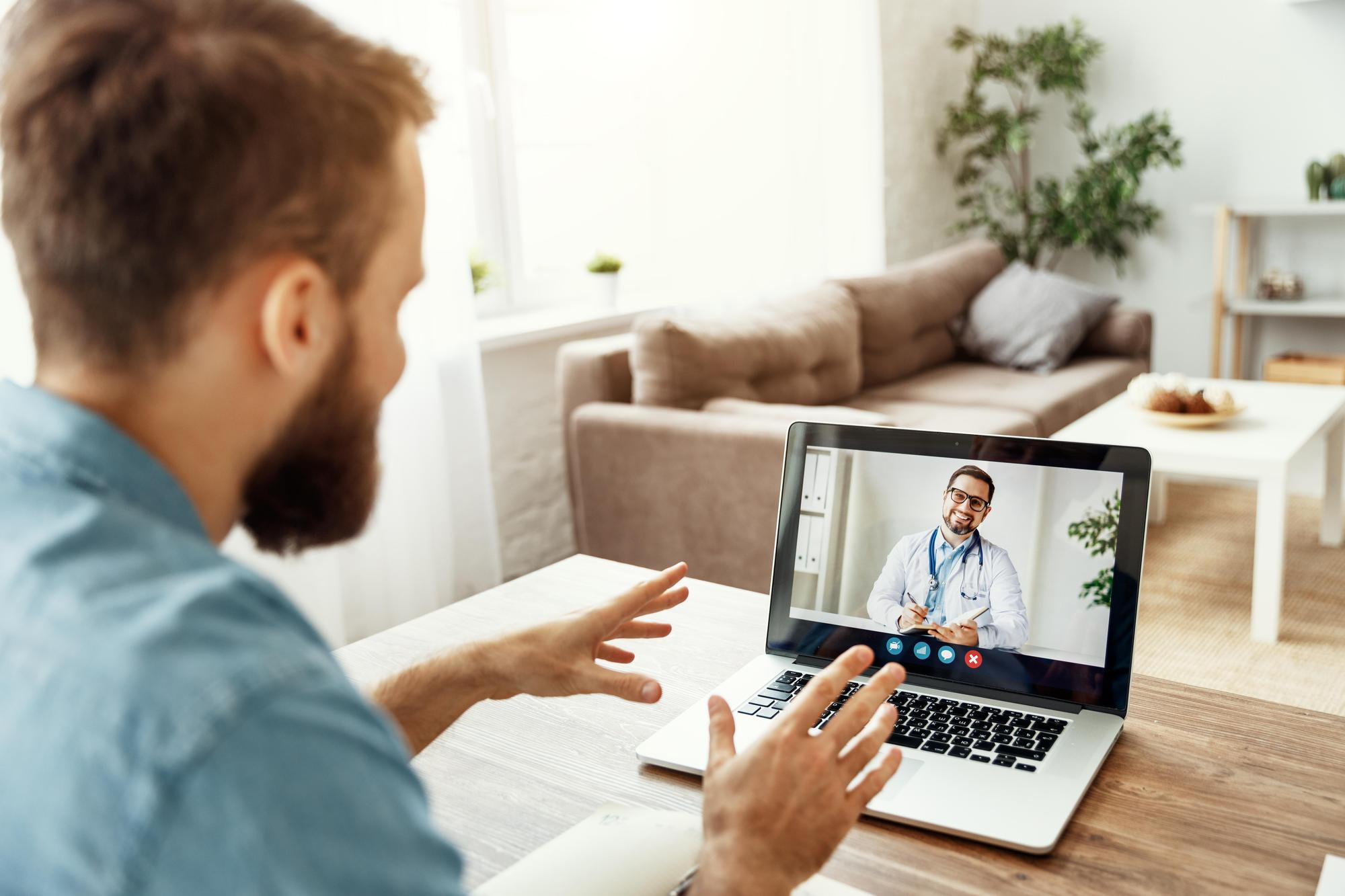 A man talks to his doctor about medication management during virtual addiction treatment in Wisconsin.
