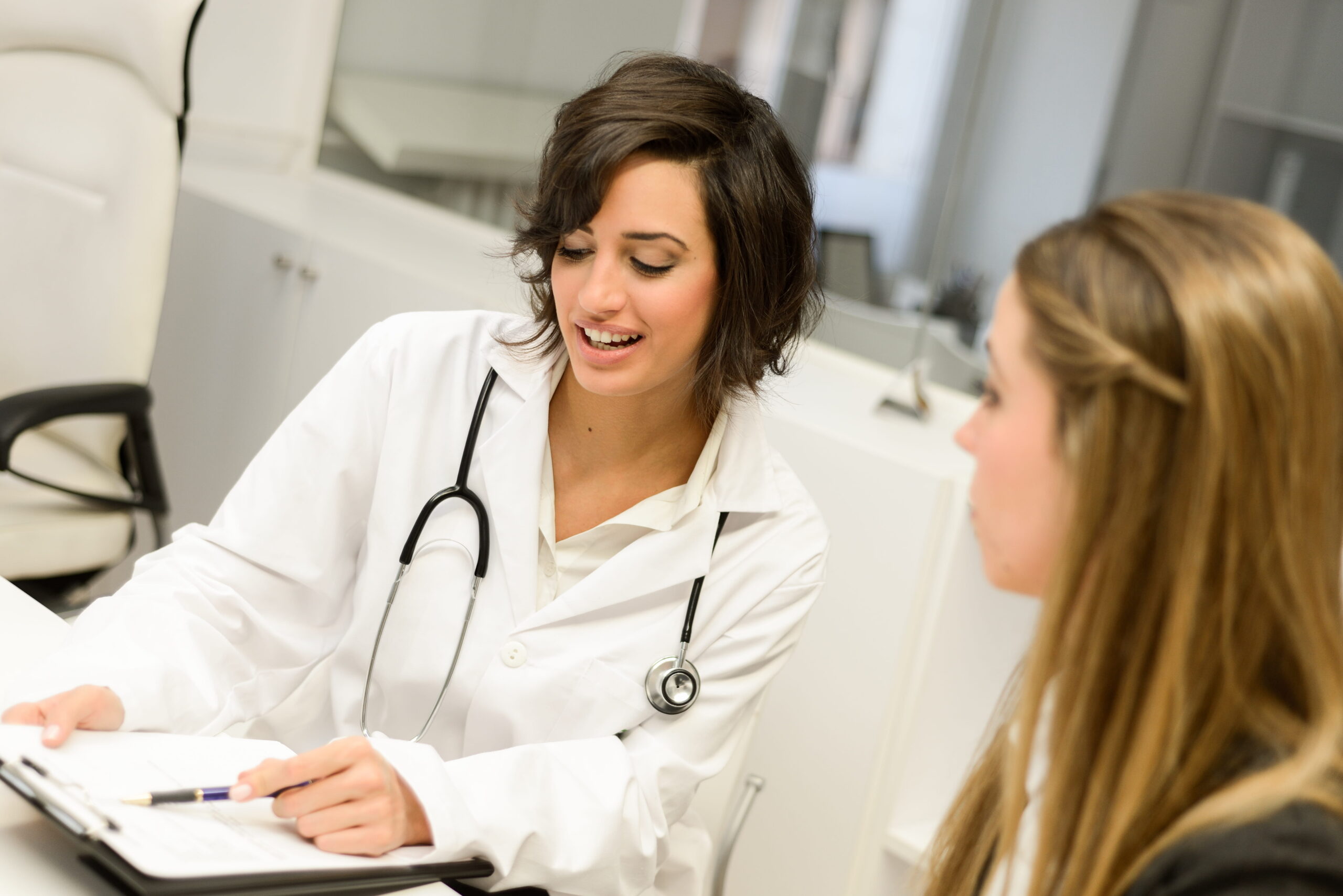 A woman talks to her doctor about medication support at our addiction IOP in Mt. Pleasant, WI.