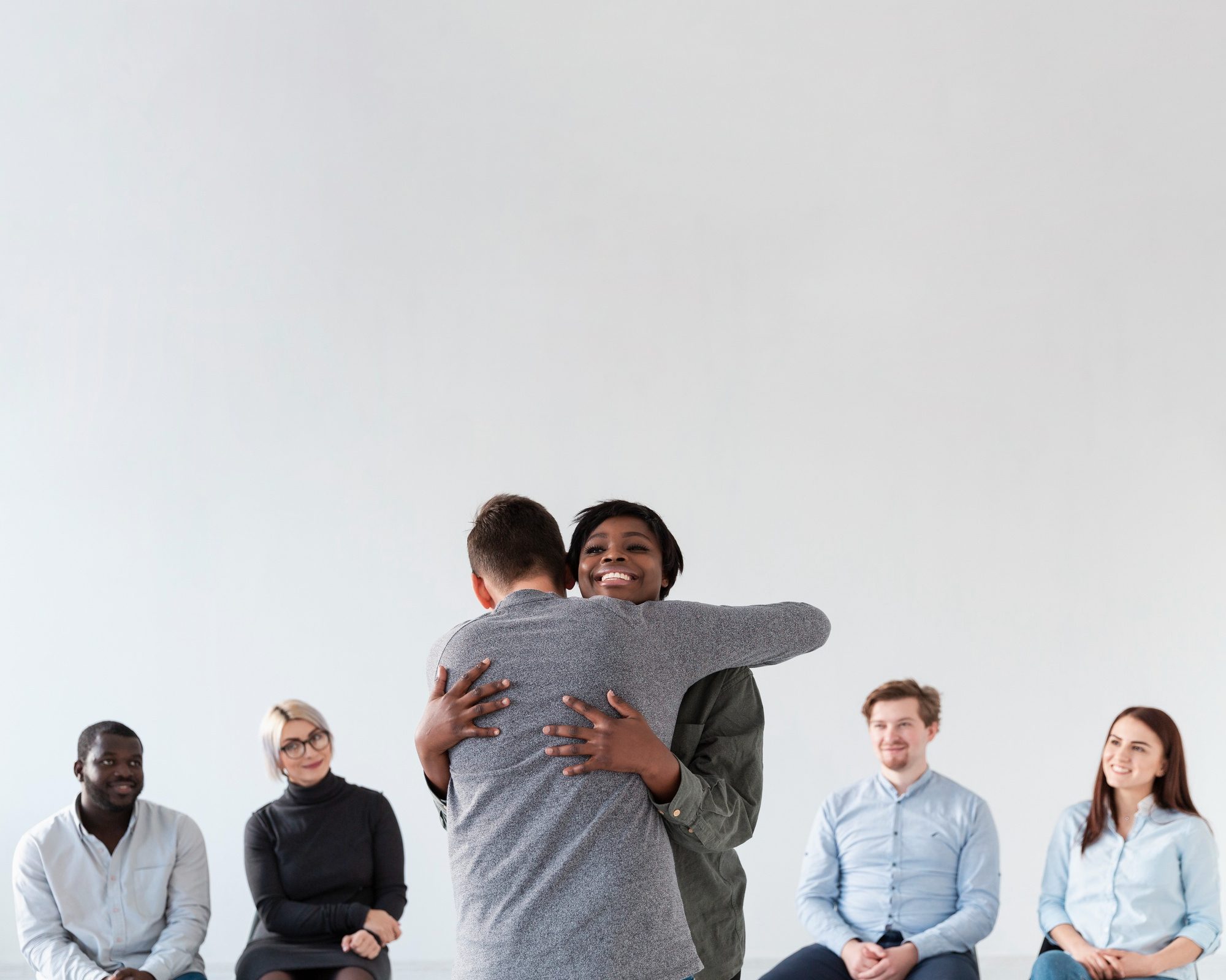Couple embracing during a group therapy session for mental health treatment in Mount Pleasant, WI.