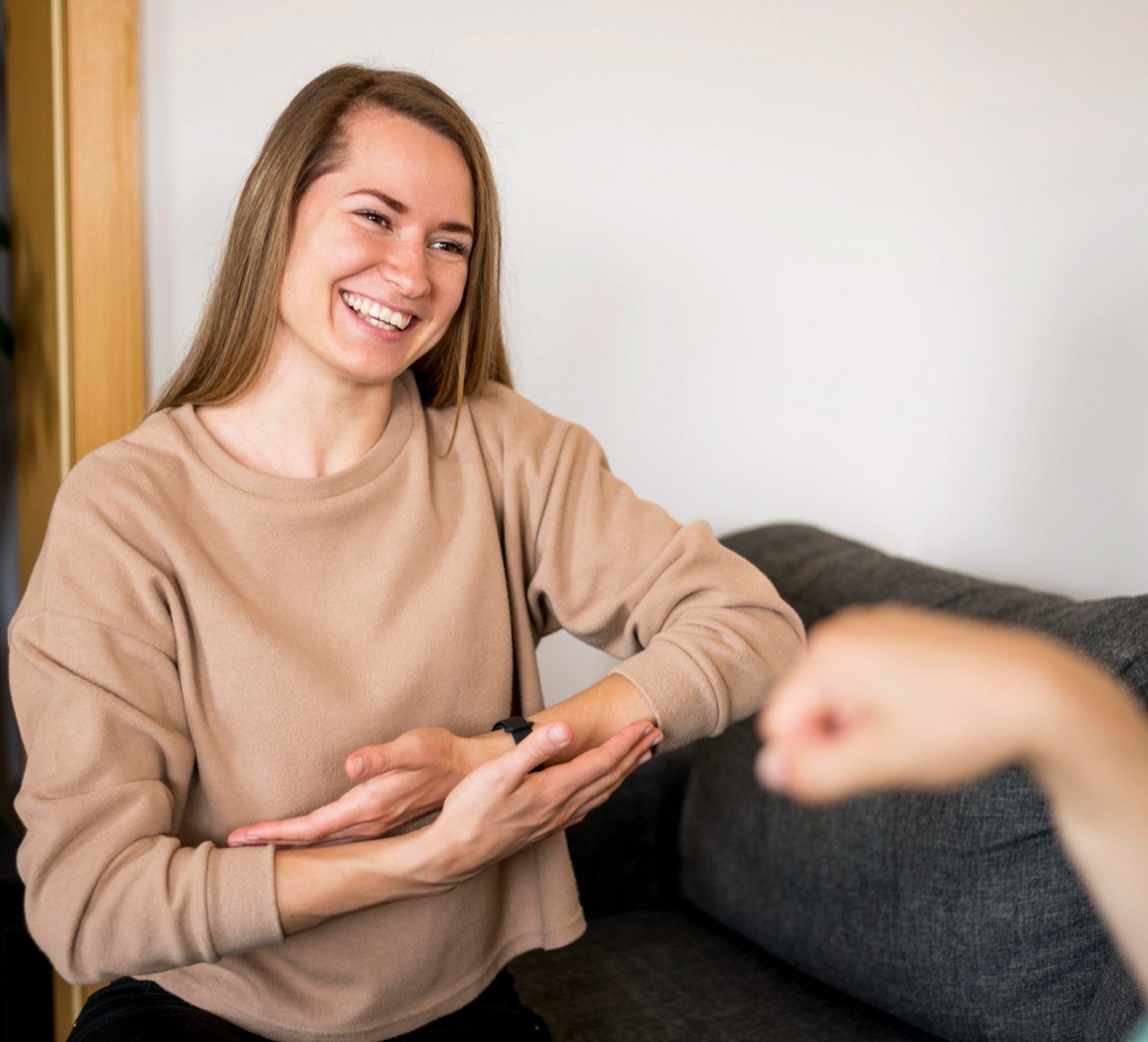 Woman smiling while interacting with her therapist during behavioral health therapy in Mount Pleasant, WI.