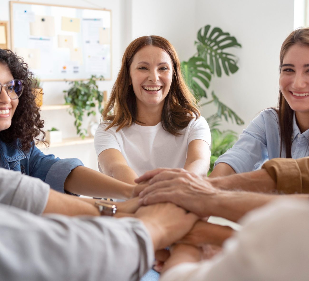 People holding hands in a therapy circle during mental health treatment in Mount Pleasant, WI.